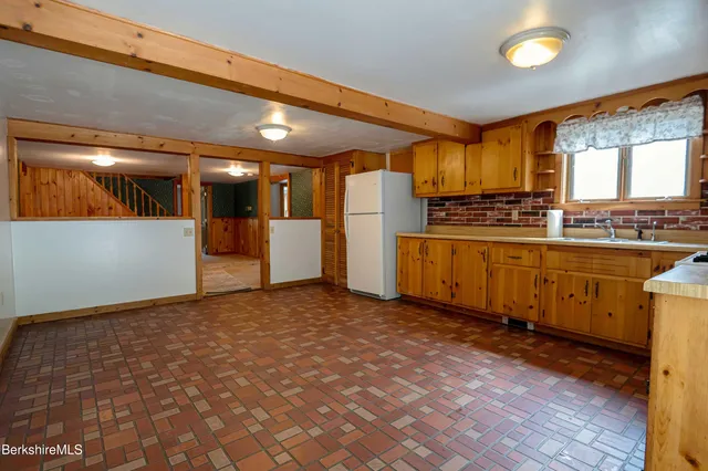 a view of a kitchen with a sink and cabinets
