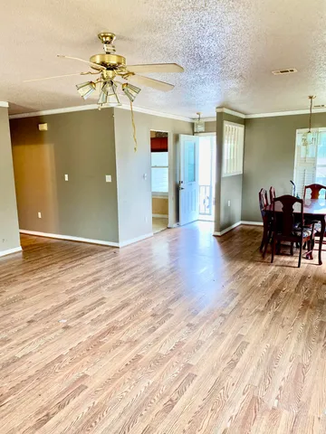 a view of a livingroom with a kitchen and an empty space