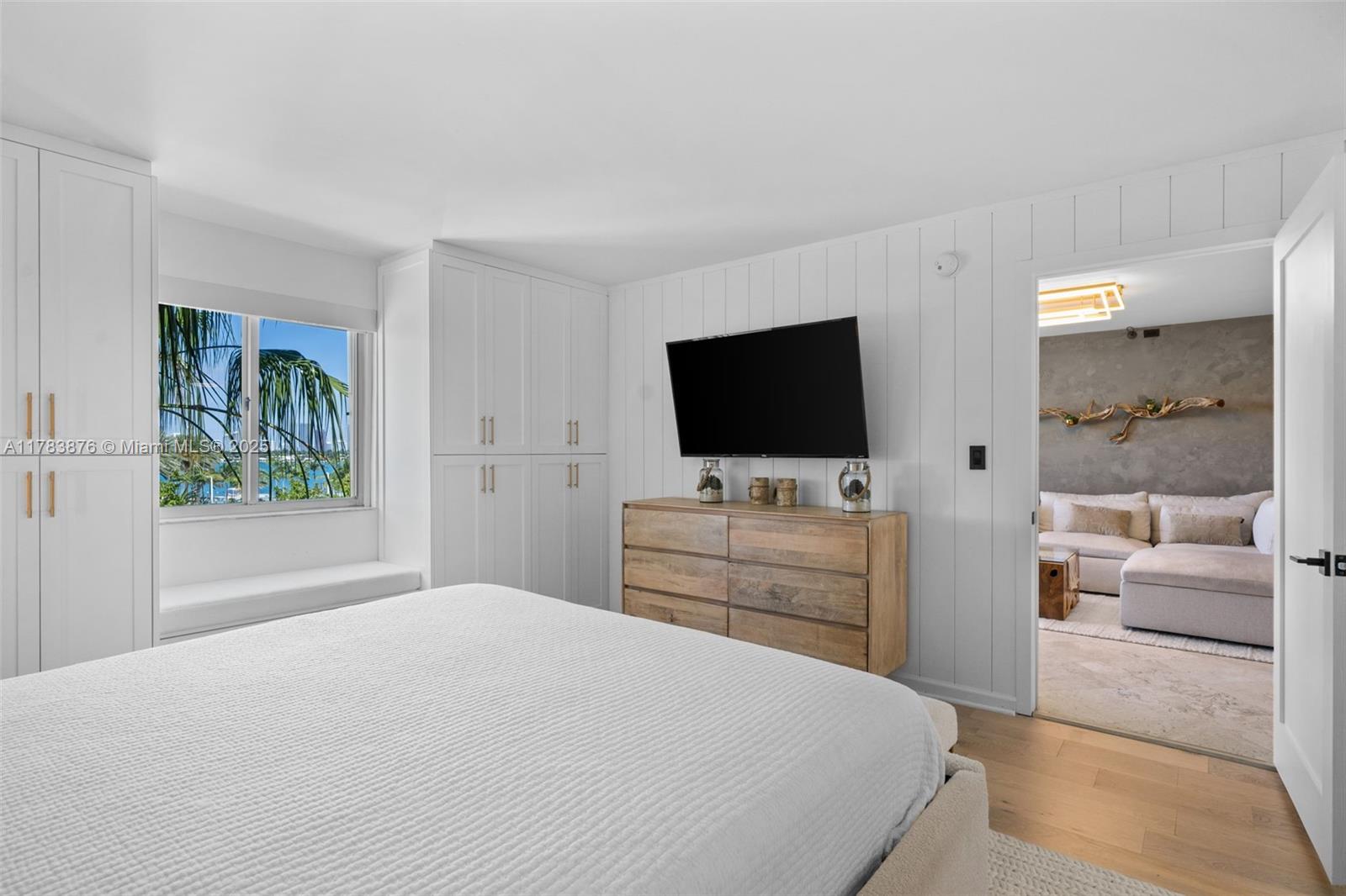 1401 Bay Road, Unit 506 Miami Beach, FL 33139 - Photo 12 of 28 a bedroom with a bed and a flat screen tv