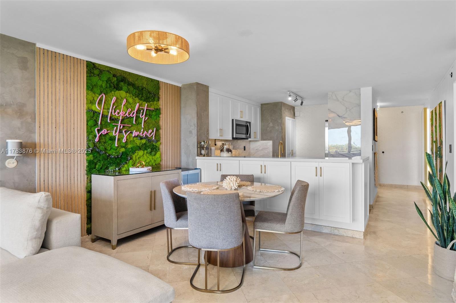 1401 Bay Road, Unit 506 Miami Beach, FL 33139 - Photo 6 of 28 a dining room with furniture a potted plant and open kitchen view