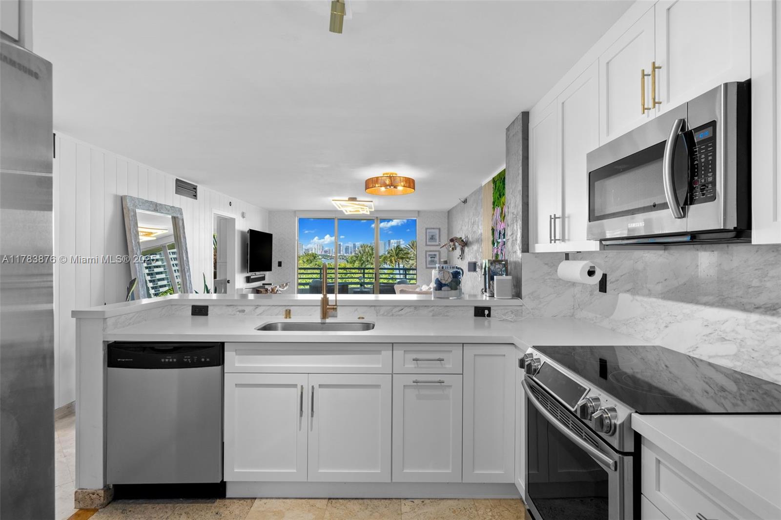 1401 Bay Road, Unit 506 Miami Beach, FL 33139 - Photo 8 of 28 a kitchen with stainless steel appliances granite countertop a sink and a stove