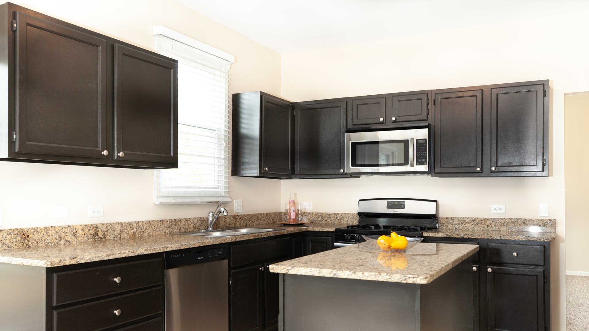 24856 Vermette Road Plainfield, IL 60585 - Photo 2 of 18 a kitchen with stainless steel appliances granite countertop a sink stove and microwave