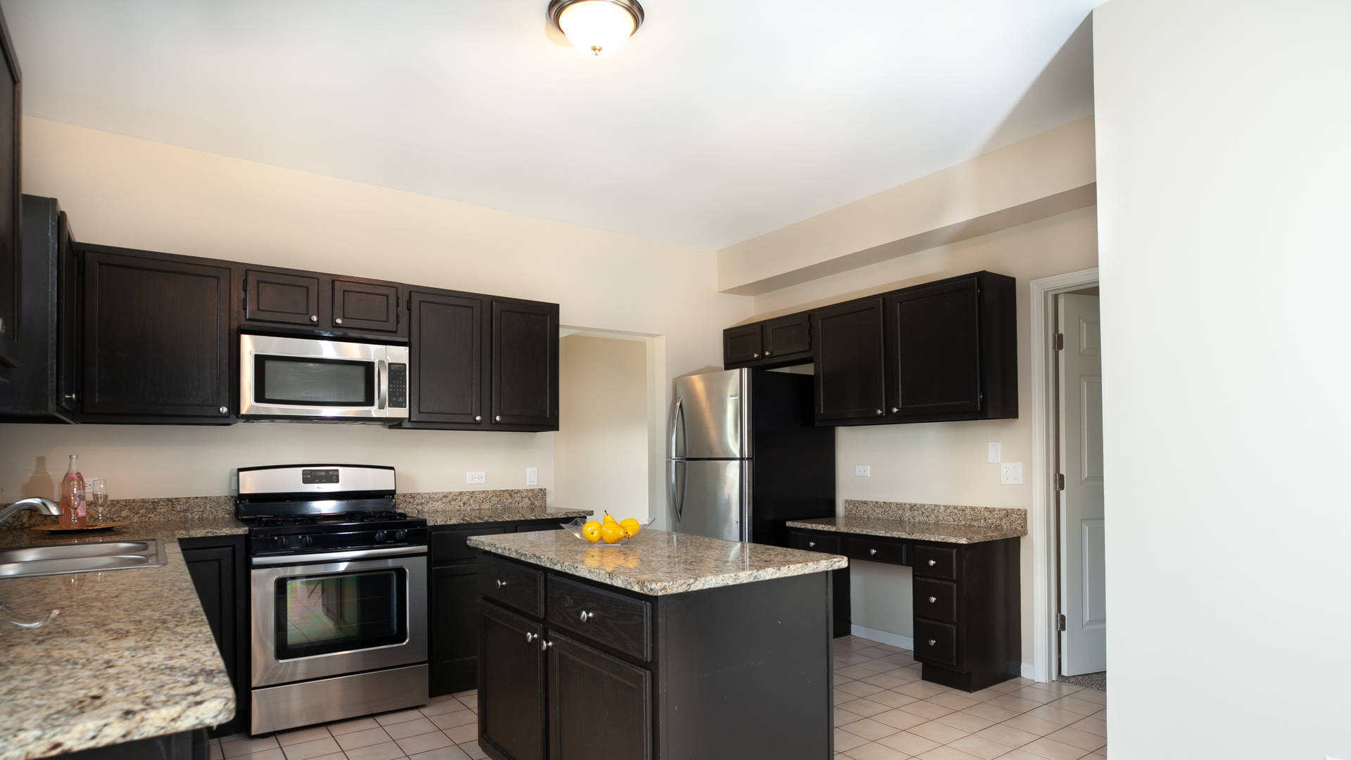 24856 Vermette Road Plainfield, IL 60585 - Photo 3 of 18 a kitchen with stainless steel appliances a stove microwave and refrigerator