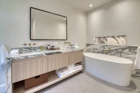 a bathroom with a granite countertop sink a mirror and a