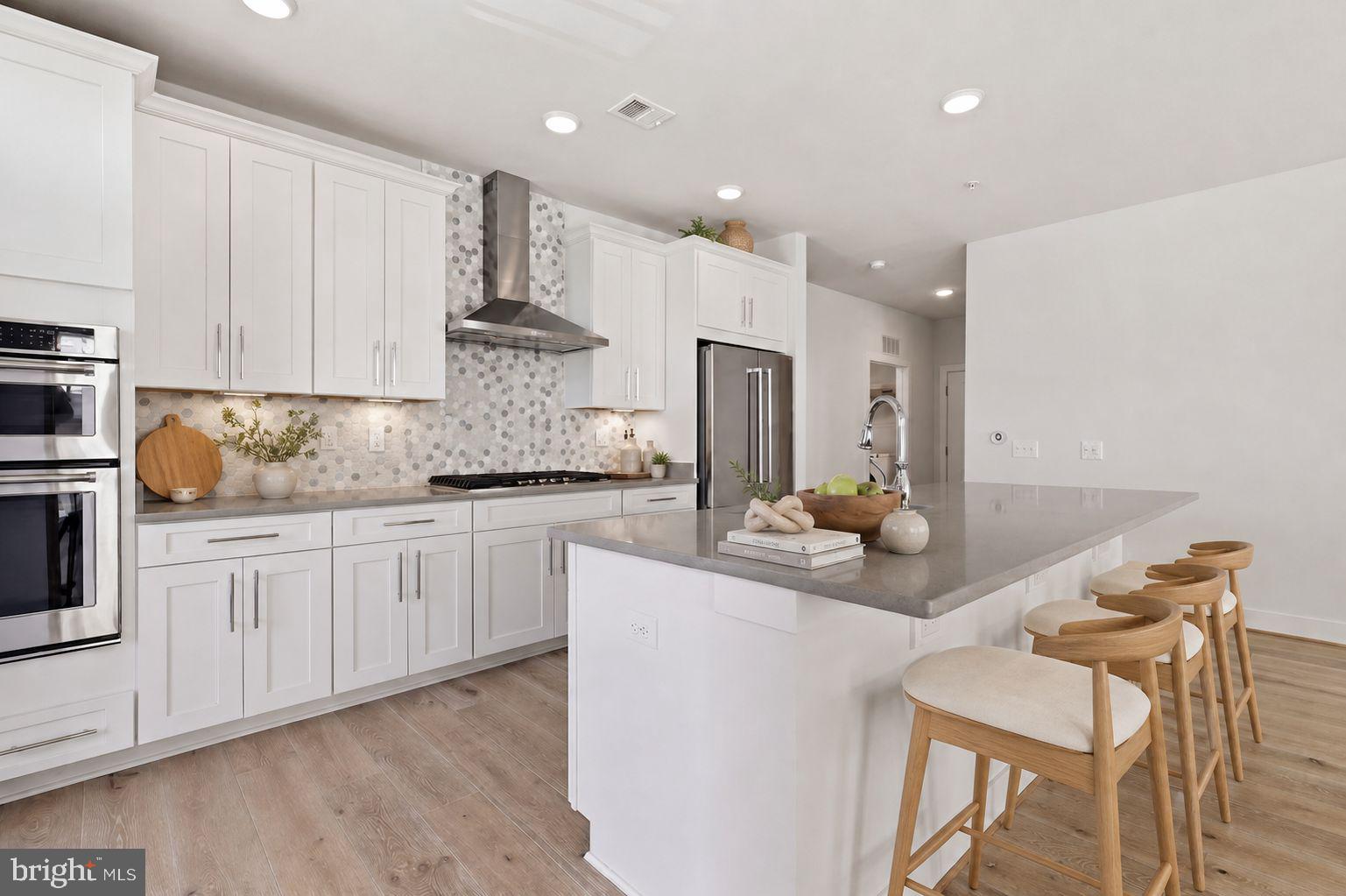 11200 Reston Station Boulevard, Unit 205 Reston, VA 20190 - Photo 1 of 3 a kitchen with stainless steel appliances granite countertop a sink and cabinets