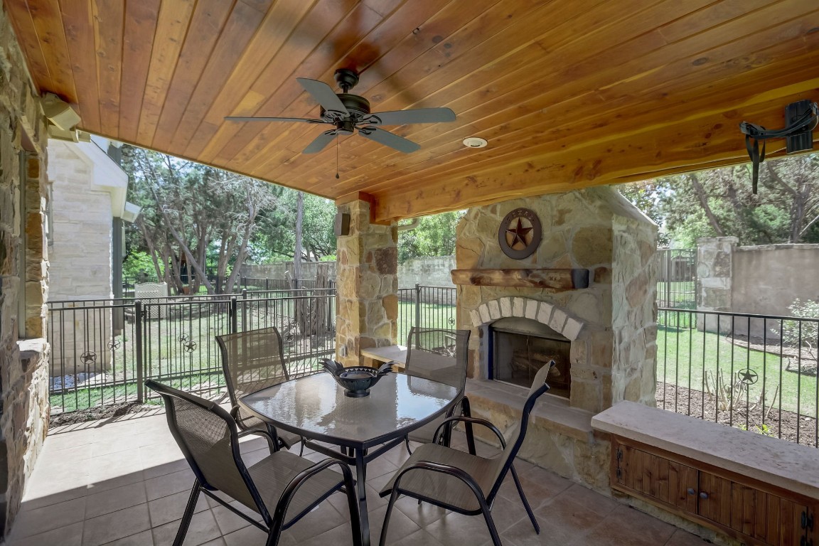 a view of a patio with a table chairs and a fireplace