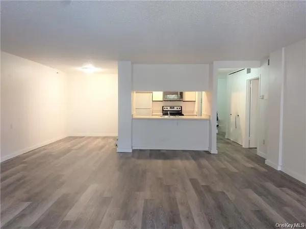 an empty room with a wooden floor and a window
