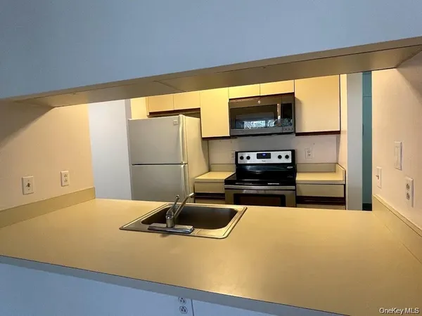 a kitchen with a refrigerator and a sink
