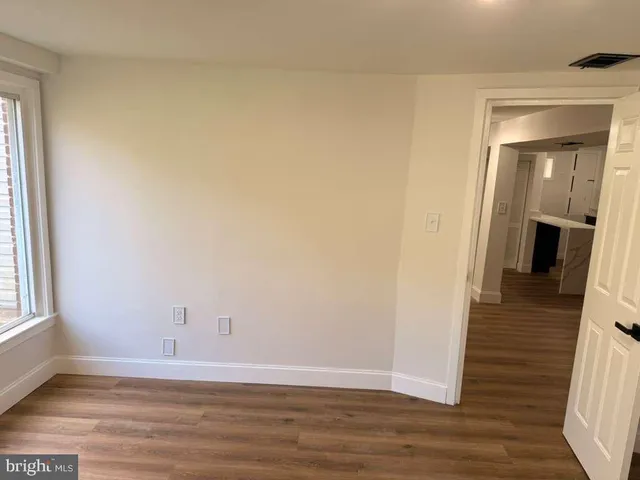 a view of a room with wooden floor and staircase