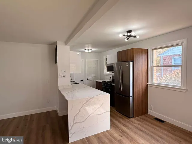 a kitchen with stainless steel appliances a refrigerator sink and cabinets