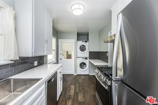 a view of a kitchen cabinets a sink and wooden floor