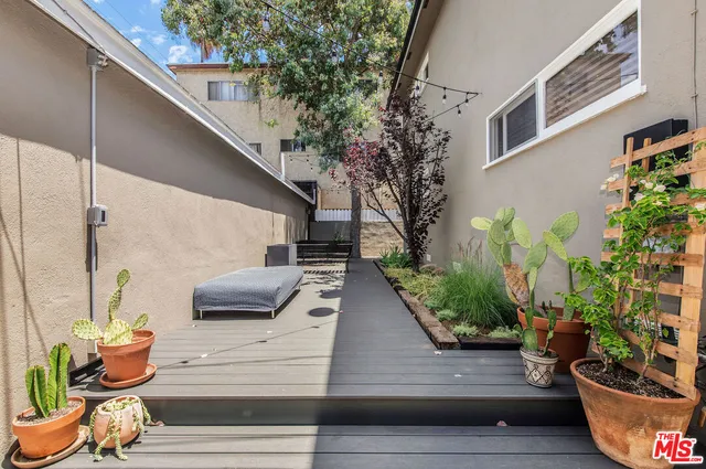 a view of a porch with furniture and potted plants