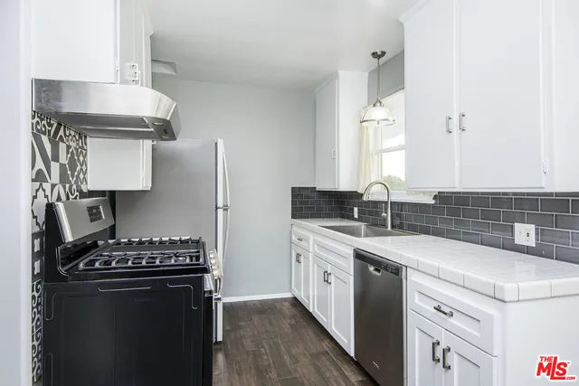 a kitchen with a stove and a sink