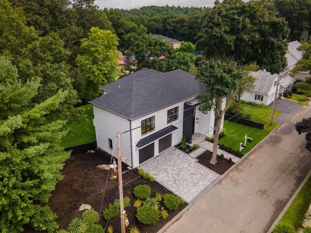 an aerial view of a house with a yard