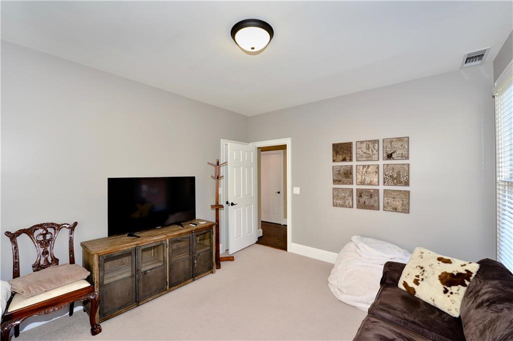 265 Windsor Gate Cove Northeast Atlanta, GA 30342 - Photo 12 of 62 a living room with furniture and a flat screen tv