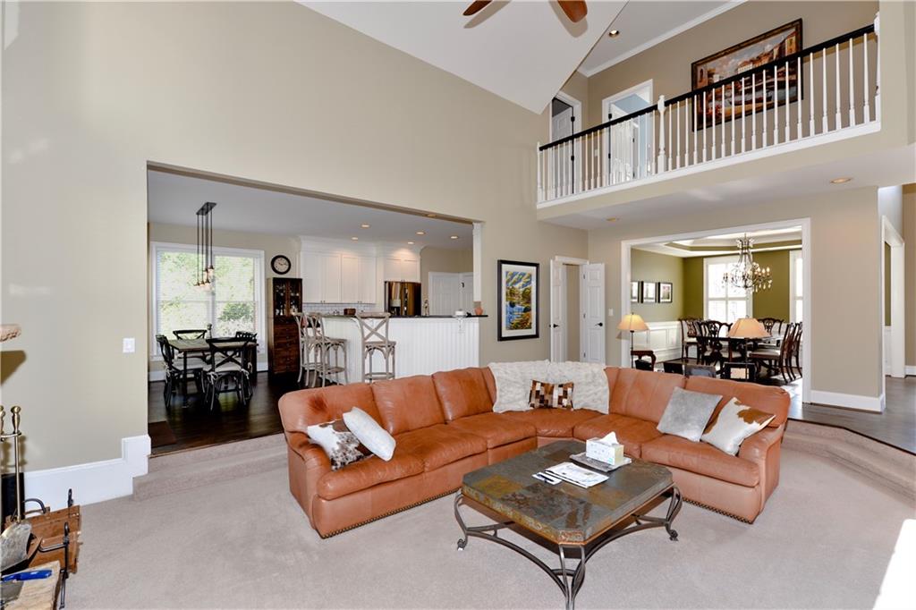 265 Windsor Gate Cove Northeast Atlanta, GA 30342 - Photo 16 of 62 a living room with furniture or couch and a dining table