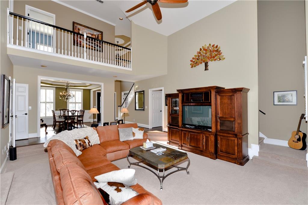 265 Windsor Gate Cove Northeast Atlanta, GA 30342 - Photo 17 of 62 a living room with furniture gym equipment and a flat screen tv