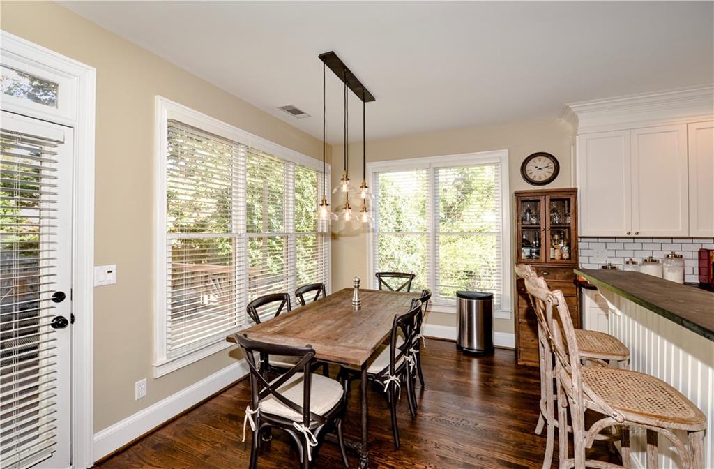 265 Windsor Gate Cove Northeast Atlanta, GA 30342 - Photo 19 of 62 a view of a dining room with furniture window and wooden floor