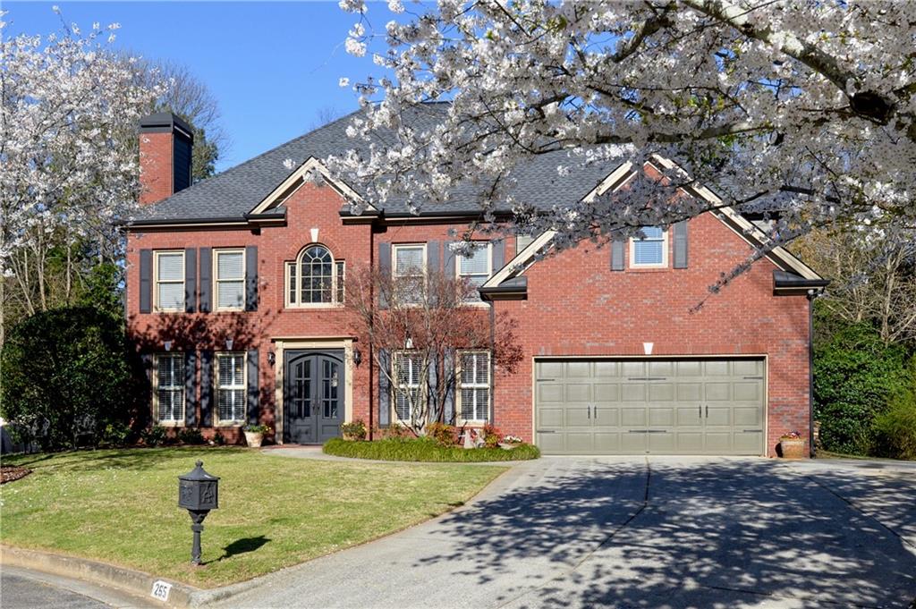 265 Windsor Gate Cove Northeast Atlanta, GA 30342 - Photo 2 of 62 a front view of a house with garden