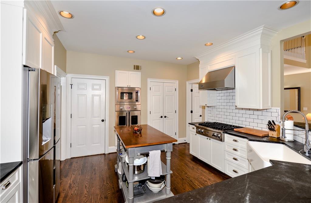 265 Windsor Gate Cove Northeast Atlanta, GA 30342 - Photo 21 of 62 a kitchen with stainless steel appliances a stove a sink and a refrigerator
