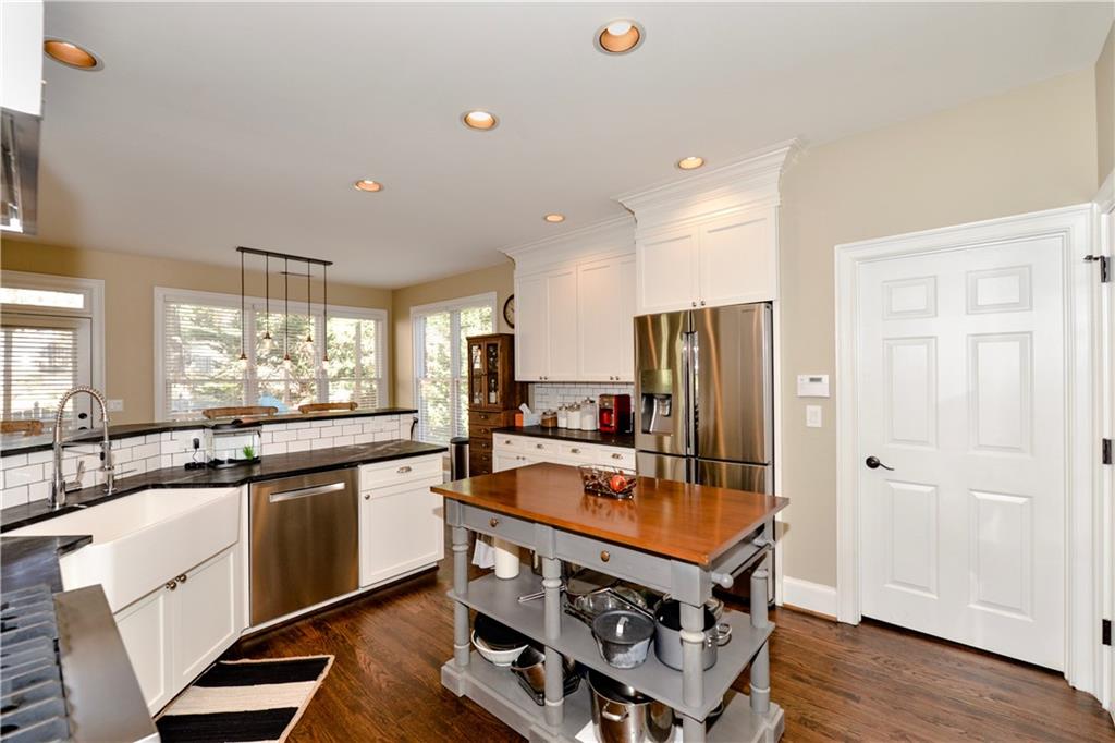 265 Windsor Gate Cove Northeast Atlanta, GA 30342 - Photo 22 of 62 a kitchen with stainless steel appliances granite countertop a stove and a refrigerator