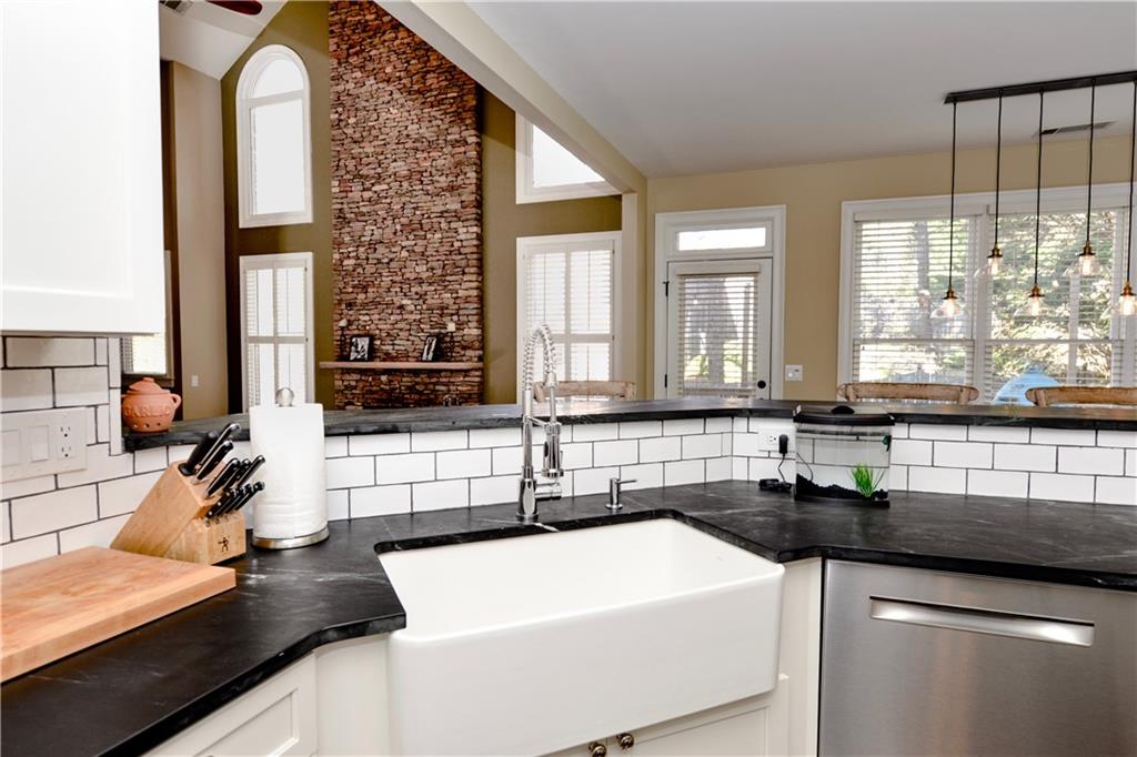 265 Windsor Gate Cove Northeast Atlanta, GA 30342 - Photo 24 of 62 a kitchen with a sink a counter and cabinets