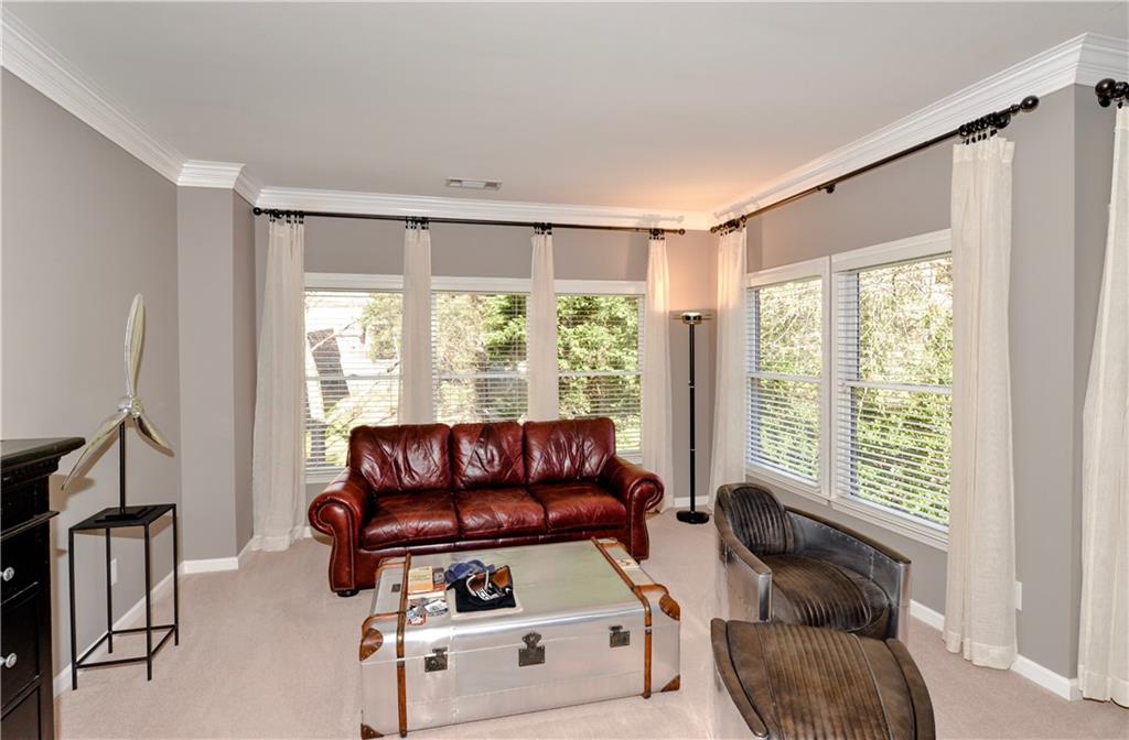 265 Windsor Gate Cove Northeast Atlanta, GA 30342 - Photo 32 of 62 a living room with furniture and a large window