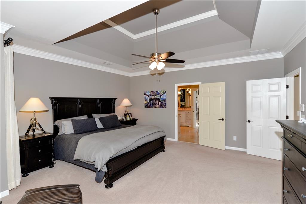 265 Windsor Gate Cove Northeast Atlanta, GA 30342 - Photo 33 of 62 a bedroom with a bed and a lamp