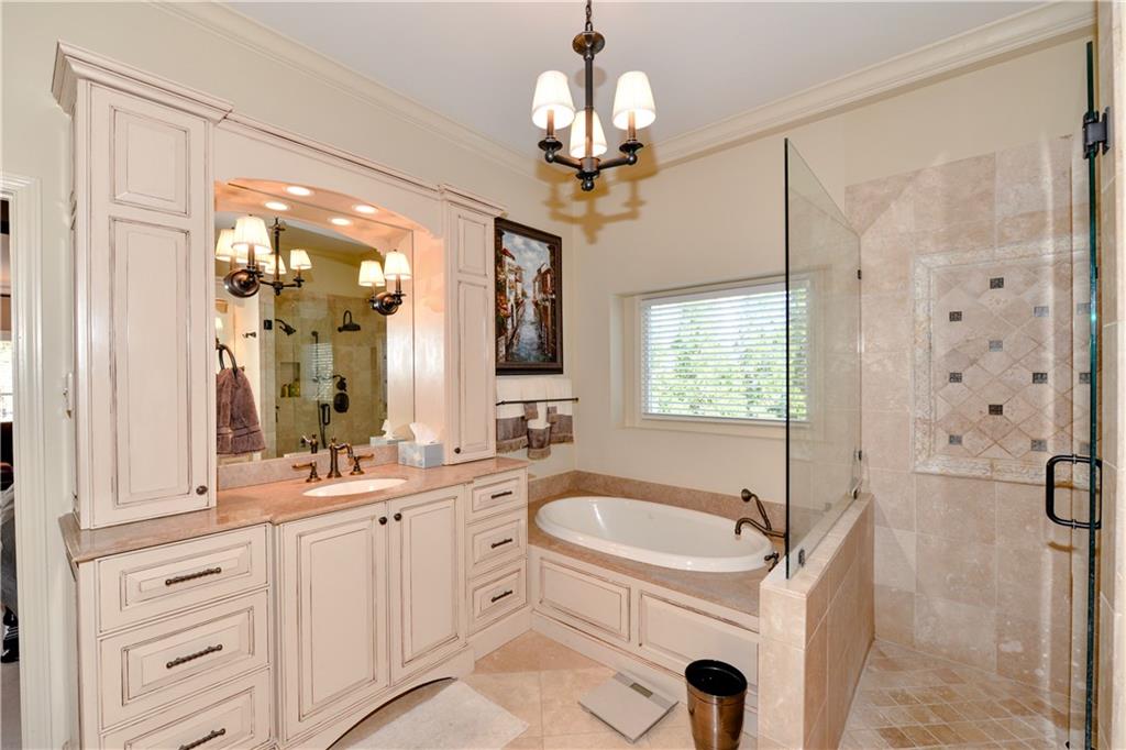 265 Windsor Gate Cove Northeast Atlanta, GA 30342 - Photo 35 of 62 a bathroom with a sink double vanity mirror and a shower