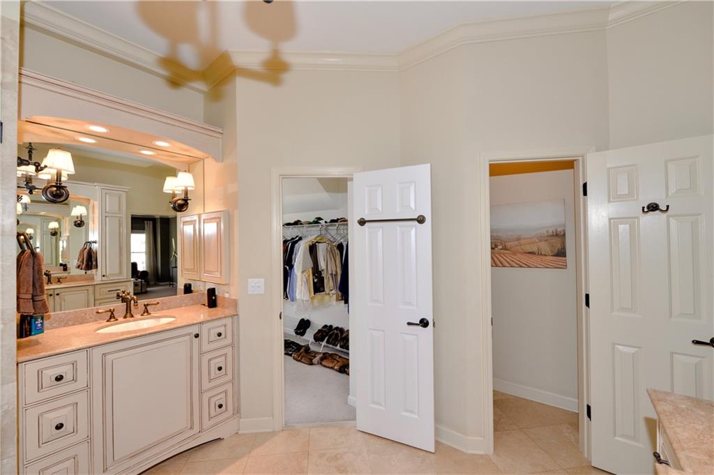 265 Windsor Gate Cove Northeast Atlanta, GA 30342 - Photo 36 of 62 a bathroom with a sink and mirror with shower