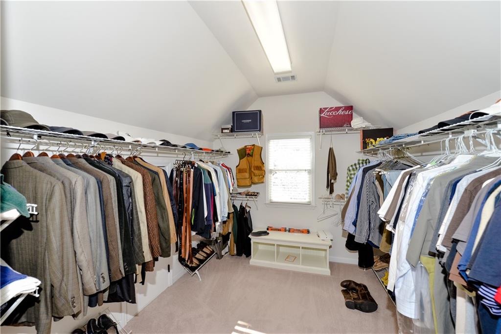 265 Windsor Gate Cove Northeast Atlanta, GA 30342 - Photo 37 of 62 a view of walk in closet with clothes and shoes