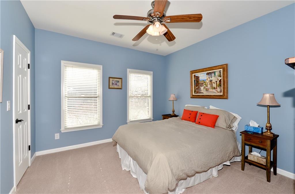 265 Windsor Gate Cove Northeast Atlanta, GA 30342 - Photo 38 of 62 a bedroom with a bed and a window