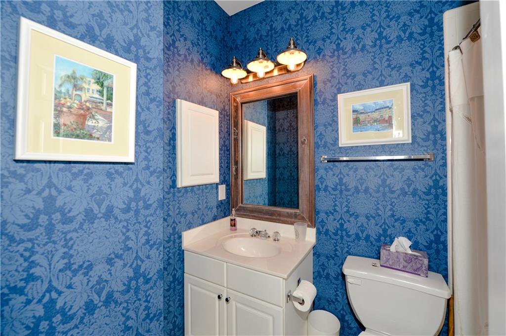 265 Windsor Gate Cove Northeast Atlanta, GA 30342 - Photo 40 of 62 a bathroom with a sink and mirror with toilet