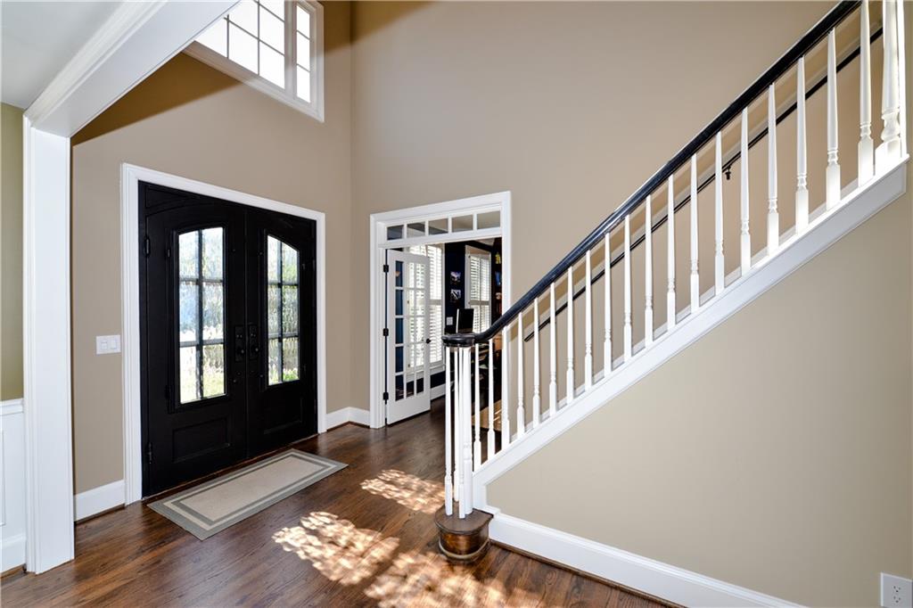 265 Windsor Gate Cove Northeast Atlanta, GA 30342 - Photo 4 of 62 a view of a hallway with wooden floor and staircase