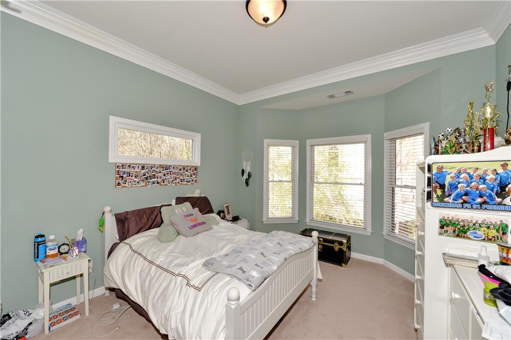 265 Windsor Gate Cove Northeast Atlanta, GA 30342 - Photo 41 of 62 a bedroom with a bed and a window