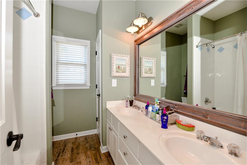 265 Windsor Gate Cove Northeast Atlanta, GA 30342 - Photo 43 of 62 a bathroom with a double vanity sink and a mirror