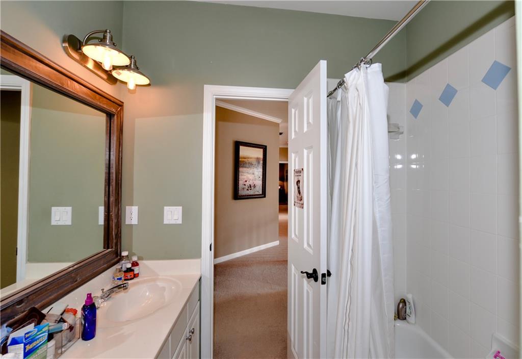 265 Windsor Gate Cove Northeast Atlanta, GA 30342 - Photo 44 of 62 a bathroom with a sink vanity and mirror