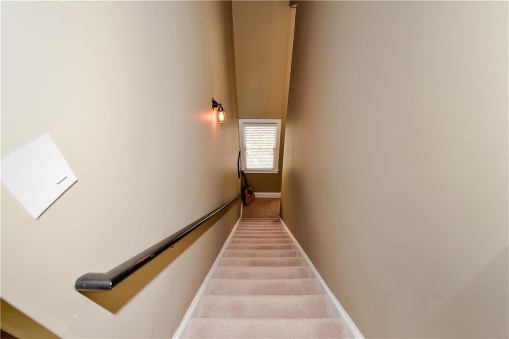 265 Windsor Gate Cove Northeast Atlanta, GA 30342 - Photo 47 of 62 a view of a hallway with wooden floor and a carpet