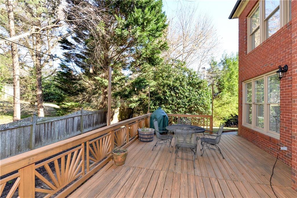 265 Windsor Gate Cove Northeast Atlanta, GA 30342 - Photo 48 of 62 a view of balcony with chairs and wooden fence