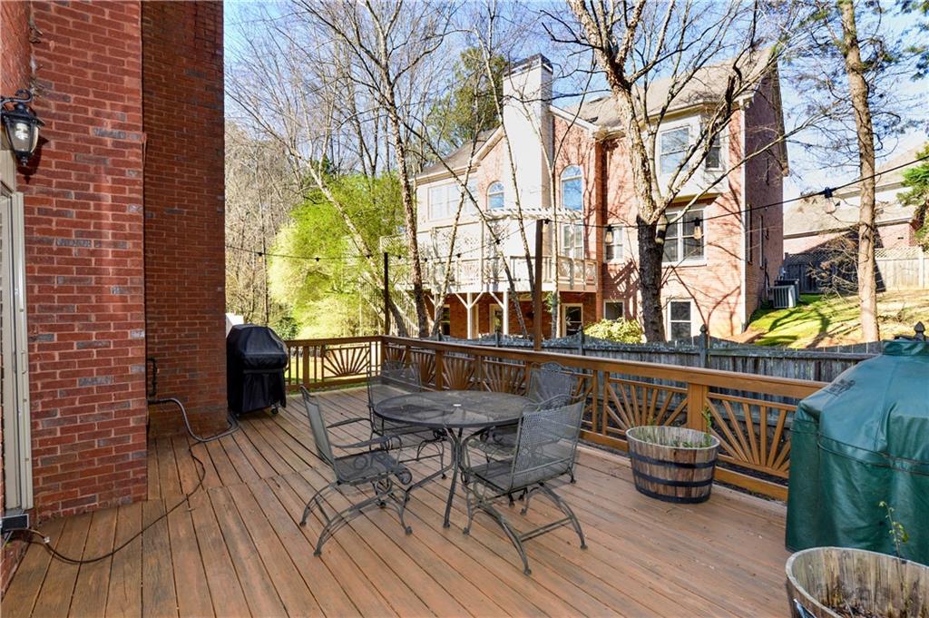 265 Windsor Gate Cove Northeast Atlanta, GA 30342 - Photo 49 of 62 a view of balcony with chairs and wooden floor