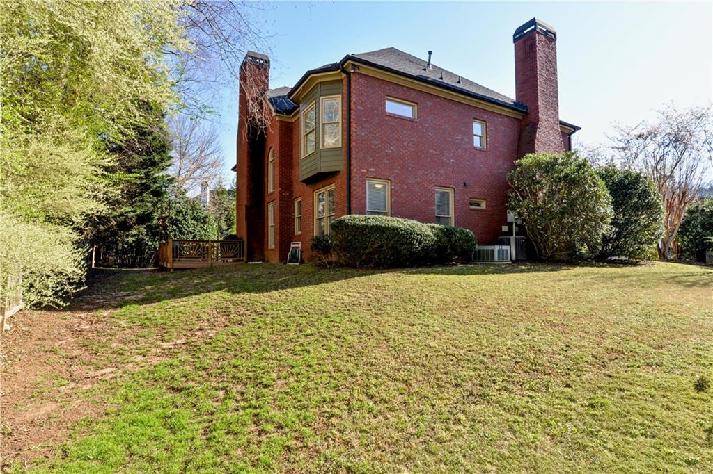 265 Windsor Gate Cove Northeast Atlanta, GA 30342 - Photo 52 of 62 a front view of a house with a yard