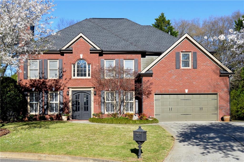265 Windsor Gate Cove Northeast Atlanta, GA 30342 - Photo 54 of 62 a front view of a house with a yard