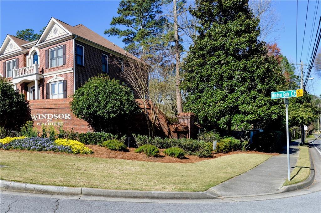 265 Windsor Gate Cove Northeast Atlanta, GA 30342 - Photo 56 of 62 a front view of a house with a yard