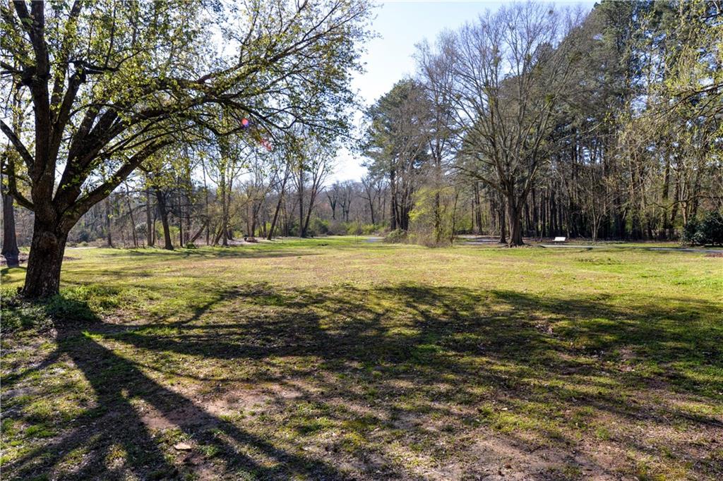 265 Windsor Gate Cove Northeast Atlanta, GA 30342 - Photo 60 of 62 a view of a field with trees in front of it
