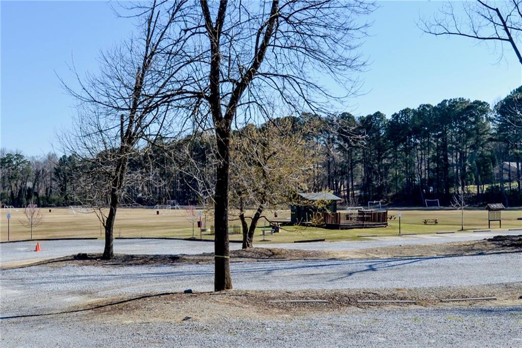 265 Windsor Gate Cove Northeast Atlanta, GA 30342 - Photo 62 of 62 a view of a yard with trees