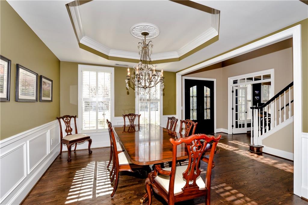 265 Windsor Gate Cove Northeast Atlanta, GA 30342 - Photo 7 of 62 a view of a dining room with furniture window and wooden floor