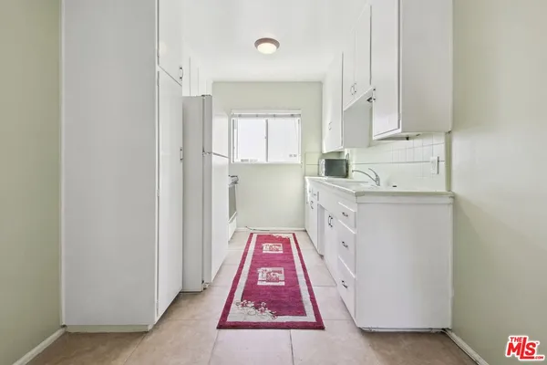 a very nice looking room with a white wooden cabinets