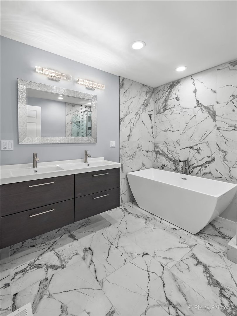 1902 South 9th Avenue Maywood, IL 60153 - Photo 13 of 51 a spacious bathroom with a tub sink and mirror