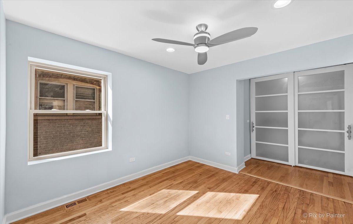 1902 South 9th Avenue Maywood, IL 60153 - Photo 20 of 51 a view of an empty room with a window and wooden floor