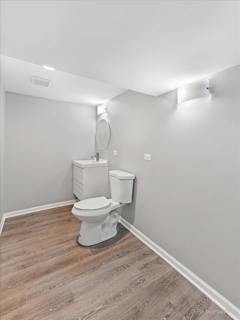 1902 South 9th Avenue Maywood, IL 60153 - Photo 33 of 51 a bathroom with a toilet and a wooden floor